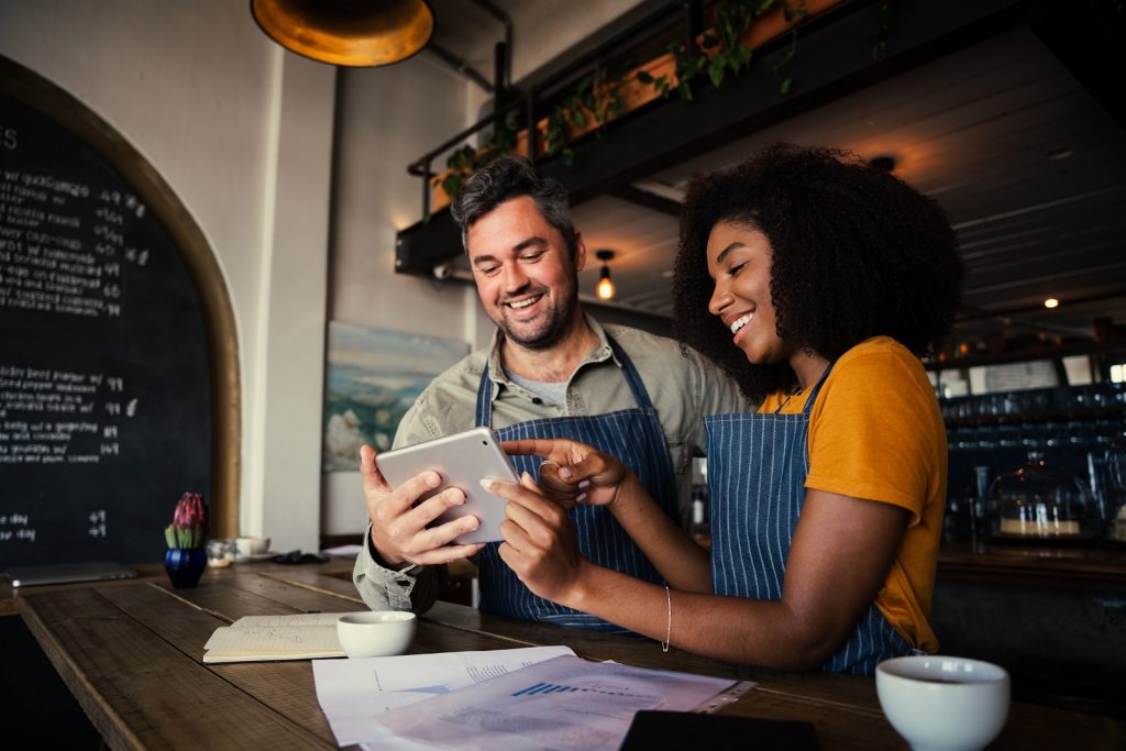 New business owners checking sales in ipad