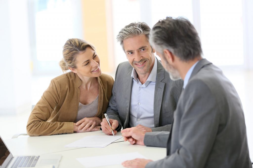 Mature couple signing documents for retirement plan